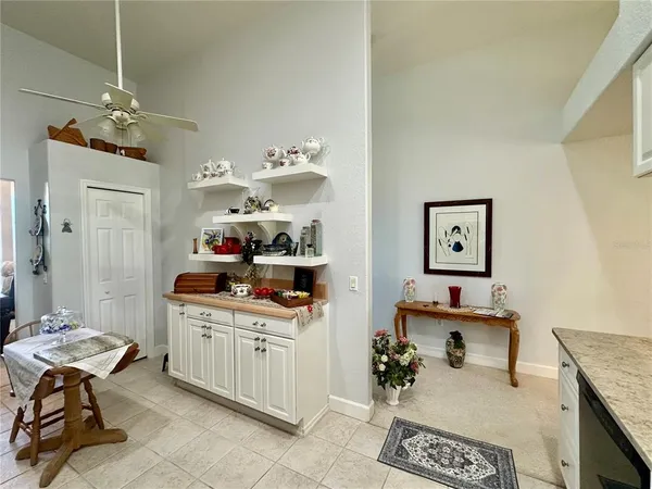 a dining room with stainless steel appliances kitchen island granite countertop furniture and a kitchen view