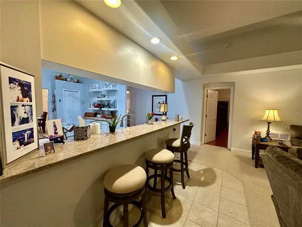 a living room with furniture ceiling fan and a window