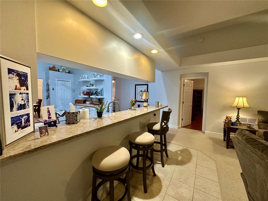 357 Ruby Lake Loop Winter Haven, FL 33884 - Photo 9 of 31 a dining room with stainless steel appliances kitchen island granite countertop furniture and a kitchen view