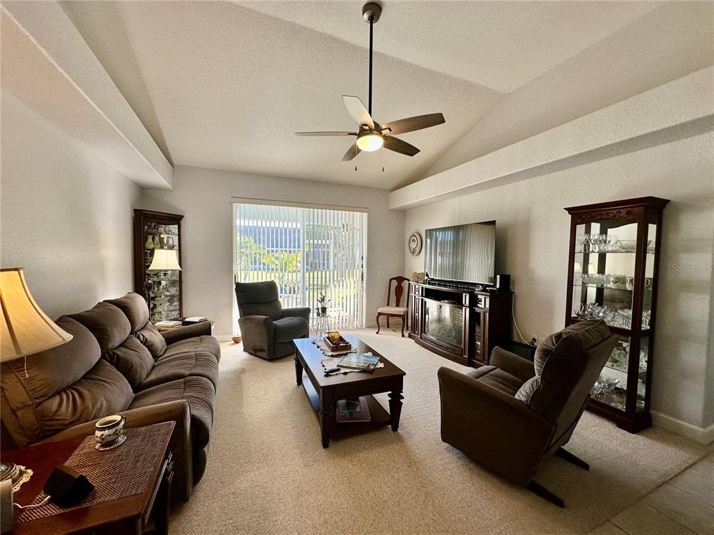 357 Ruby Lake Loop Winter Haven, FL 33884 - Photo 10 of 31 a living room with furniture ceiling fan and a window