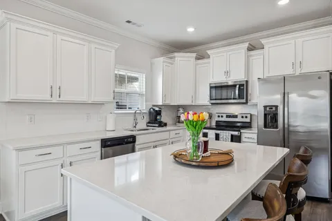 a kitchen with sink a stove and microwave