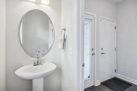 a bathroom with a sink a mirror and a toilet