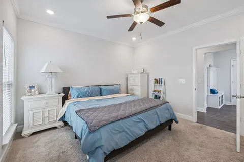 a bedroom with a large bed and a chandelier