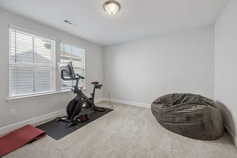 a room with gym equipment and a window