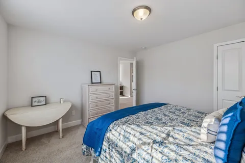 a bedroom with a bed and a chair