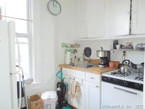 a view of a kitchen with sink and washing machine