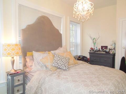 25 High Street, Unit 21 New Haven, CT 06510 - Photo 5 of 6 a bedroom with a large bed and a chandelier