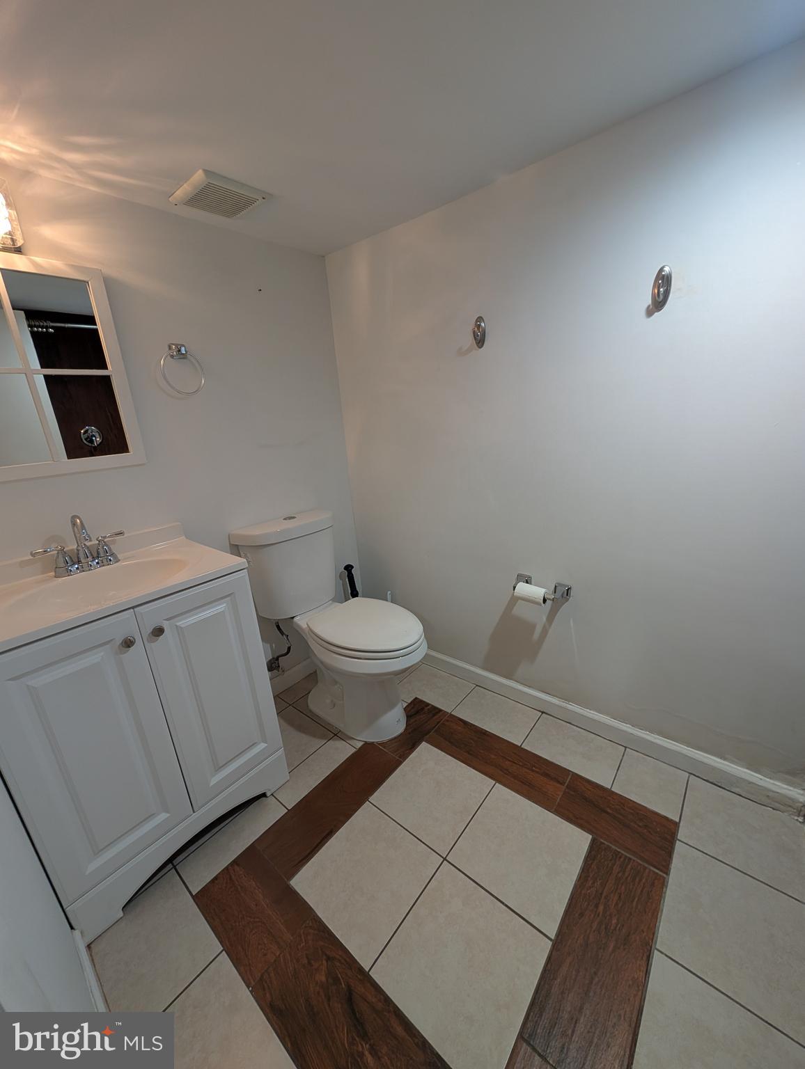 9000 Colesville Road Silver Spring, MD 20910 - Photo 6 of 9 a bathroom with a sink toilet and mirror