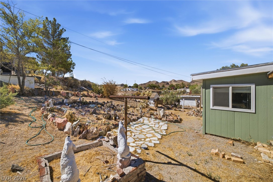 405 Main Street Beatty, NV 89003 - Photo 21 of 28 A modest desert retreat offering panoramic mountain vistas under an expansive blue sky.