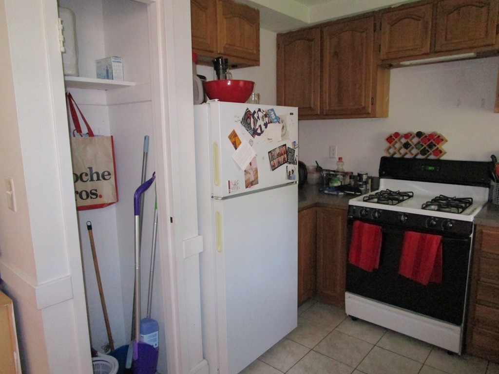 6 O'Leary Way, Unit 82 Boston, MA 02130 - Photo 9 of 14 a kitchen with stainless steel appliances granite countertop a refrigerator and a stove