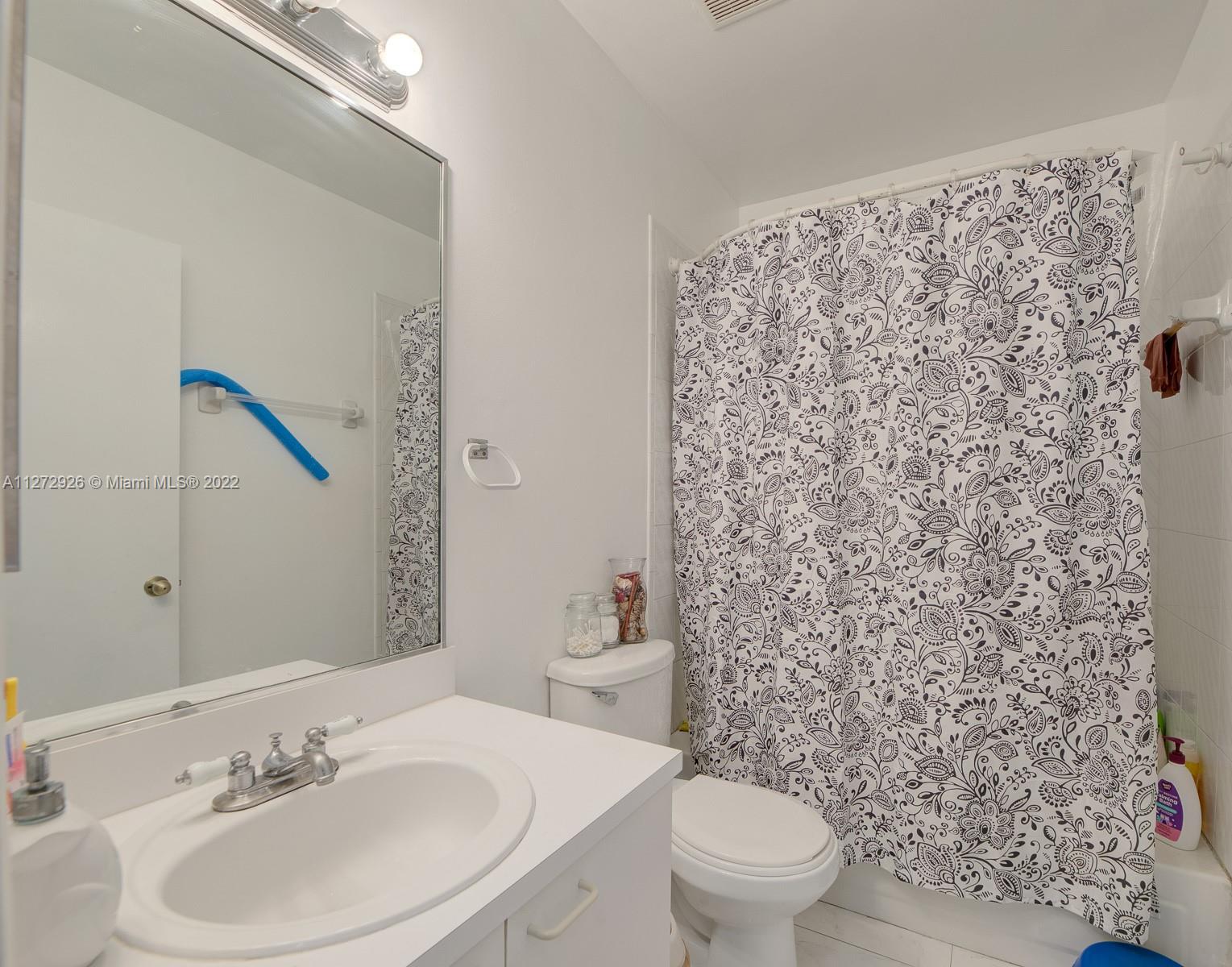 14480 Southwest 112th Street Miami, FL 33186 - Photo 11 of 37 a bathroom with a sink toilet and mirror