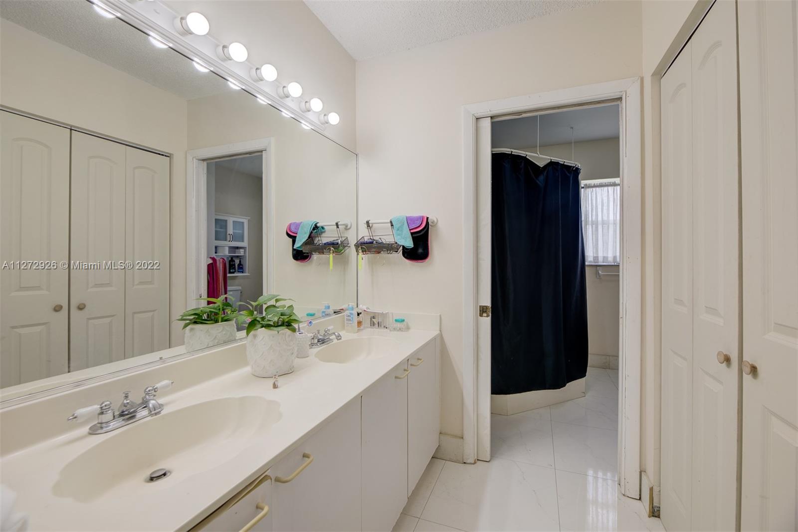 14480 Southwest 112th Street Miami, FL 33186 - Photo 15 of 37 a spacious bathroom with a bathtub sink and mirror