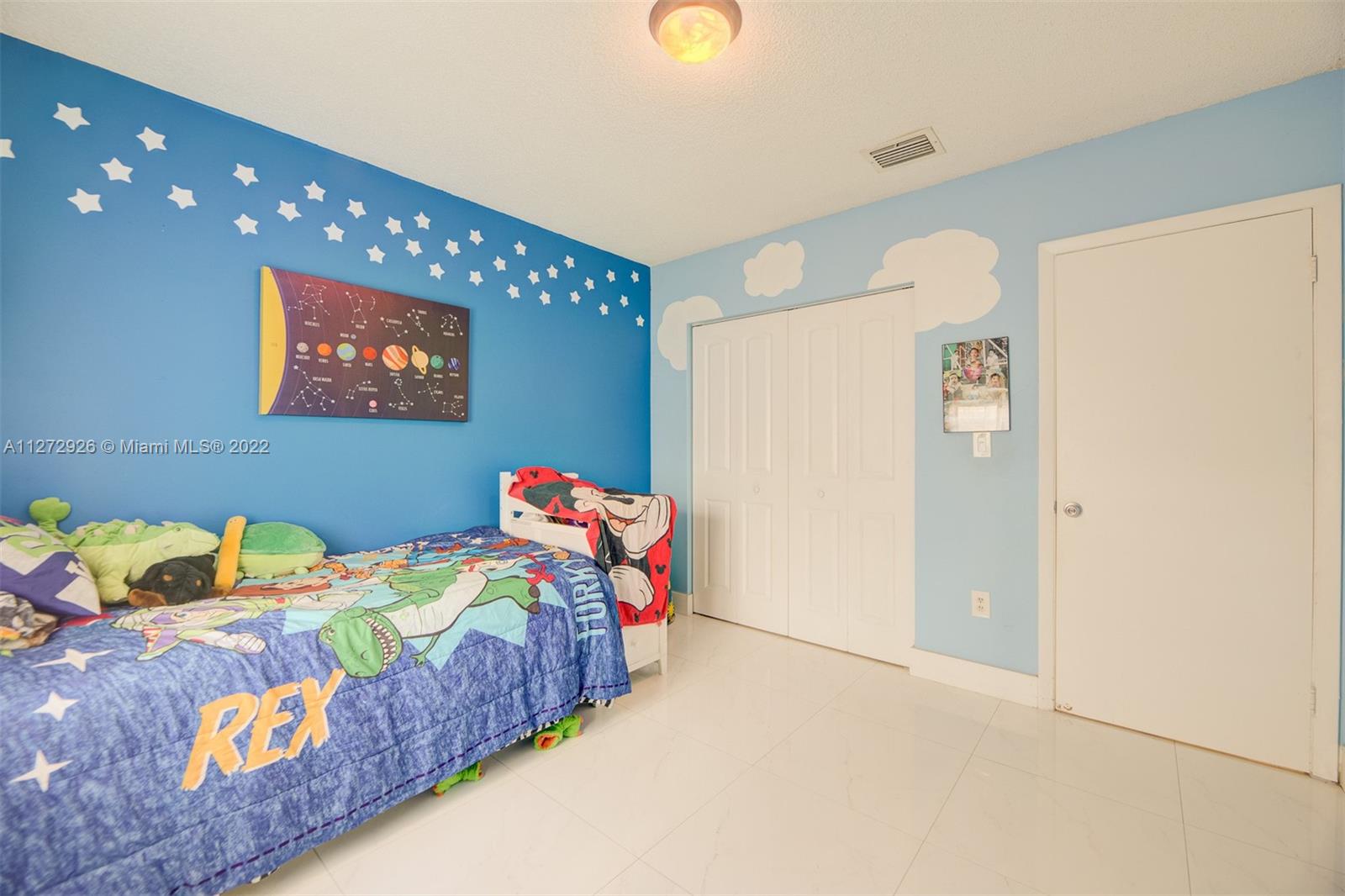 14480 Southwest 112th Street Miami, FL 33186 - Photo 18 of 37 a bedroom that has a bed and a painting on the wall