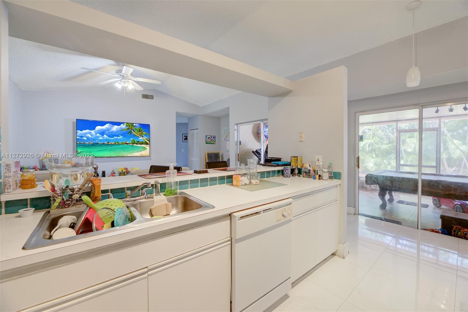 14480 Southwest 112th Street Miami, FL 33186 - Photo 20 of 37 a kitchen that has a sink and a stove with wooden floor