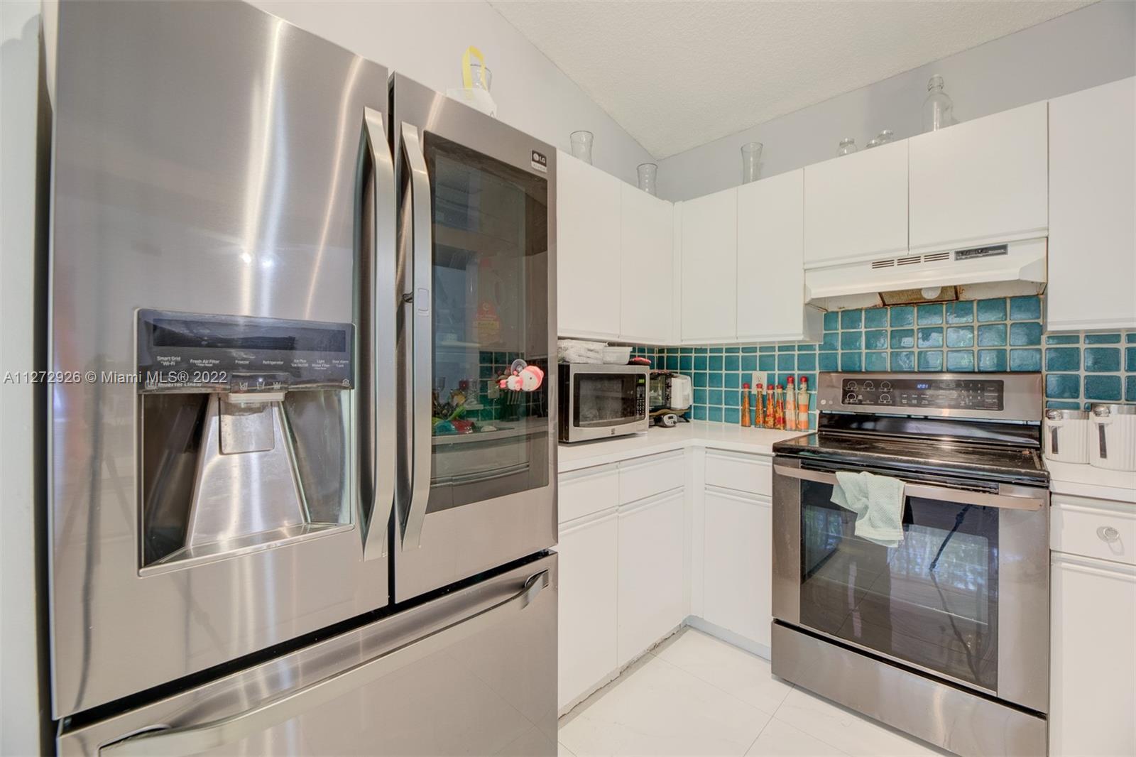 14480 Southwest 112th Street Miami, FL 33186 - Photo 2 of 37 a kitchen with a stove and a refrigerator