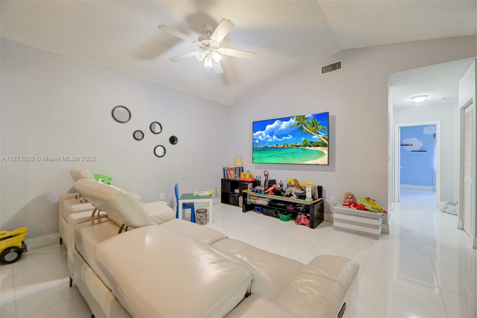 14480 Southwest 112th Street Miami, FL 33186 - Photo 21 of 37 a living room with furniture chess board and a chandelier