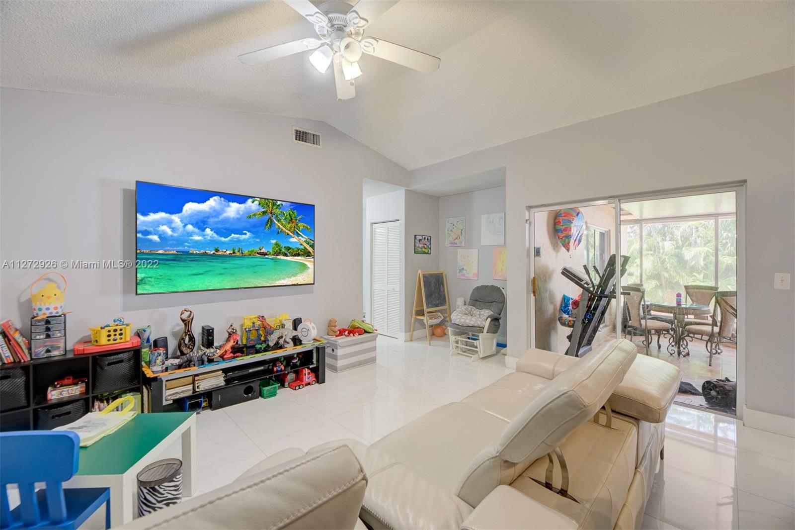 14480 Southwest 112th Street Miami, FL 33186 - Photo 22 of 37 a living room with furniture and a flat screen tv