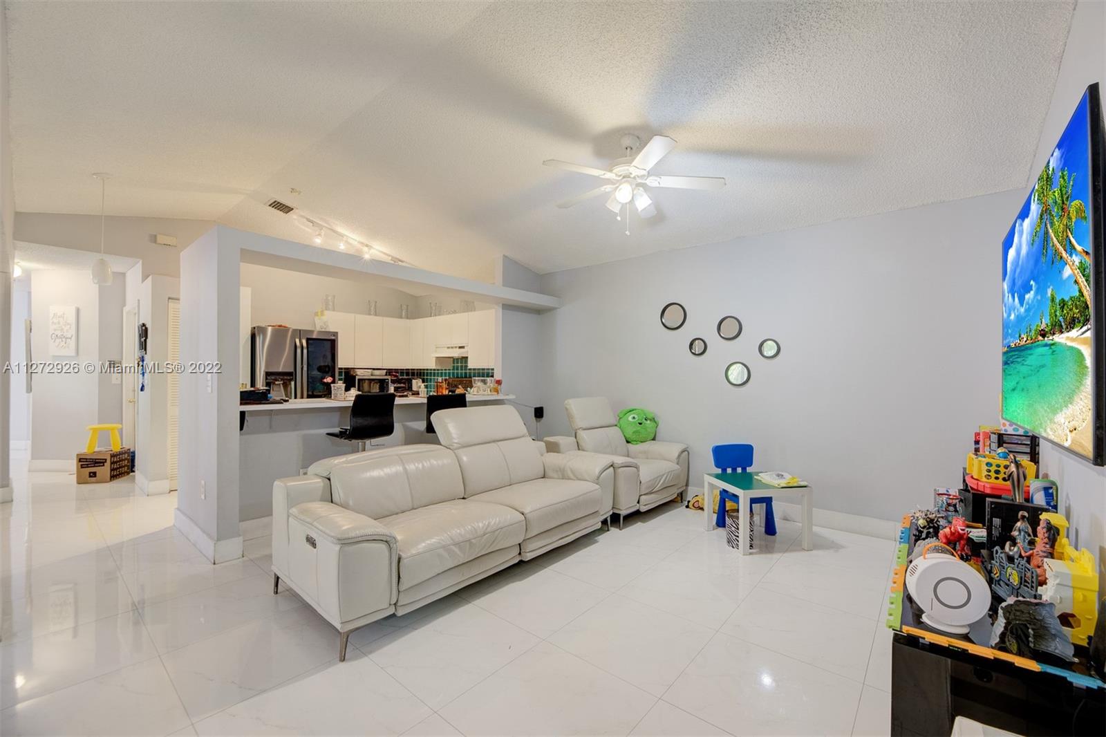14480 Southwest 112th Street Miami, FL 33186 - Photo 23 of 37 a living room with furniture and a chandelier