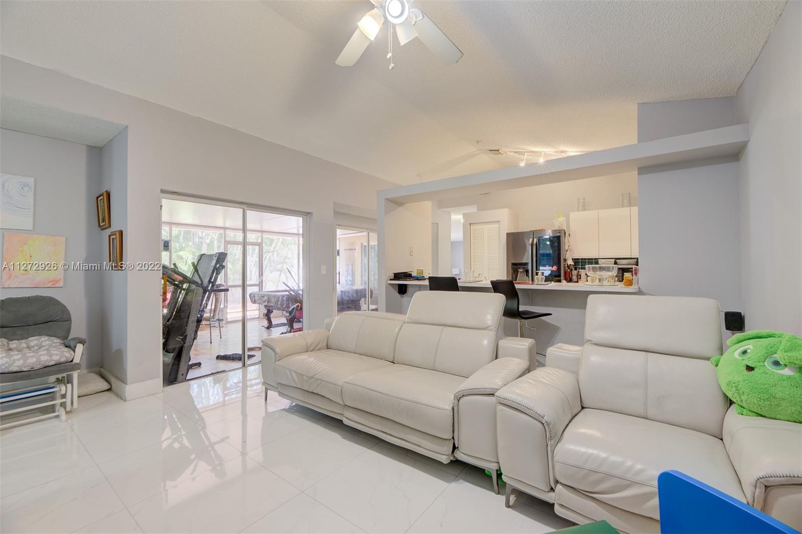 14480 Southwest 112th Street Miami, FL 33186 - Photo 24 of 37 a living room with furniture and a large window