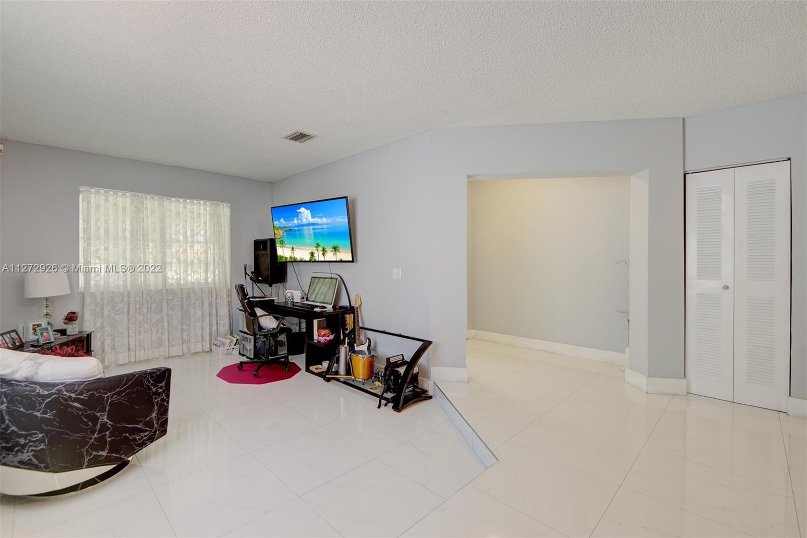 14480 Southwest 112th Street Miami, FL 33186 - Photo 27 of 37 a room with furniture and musical instruments