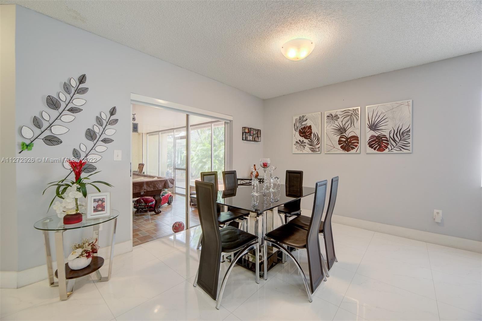 14480 Southwest 112th Street Miami, FL 33186 - Photo 28 of 37 a view of a livingroom with furniture and a potted plant