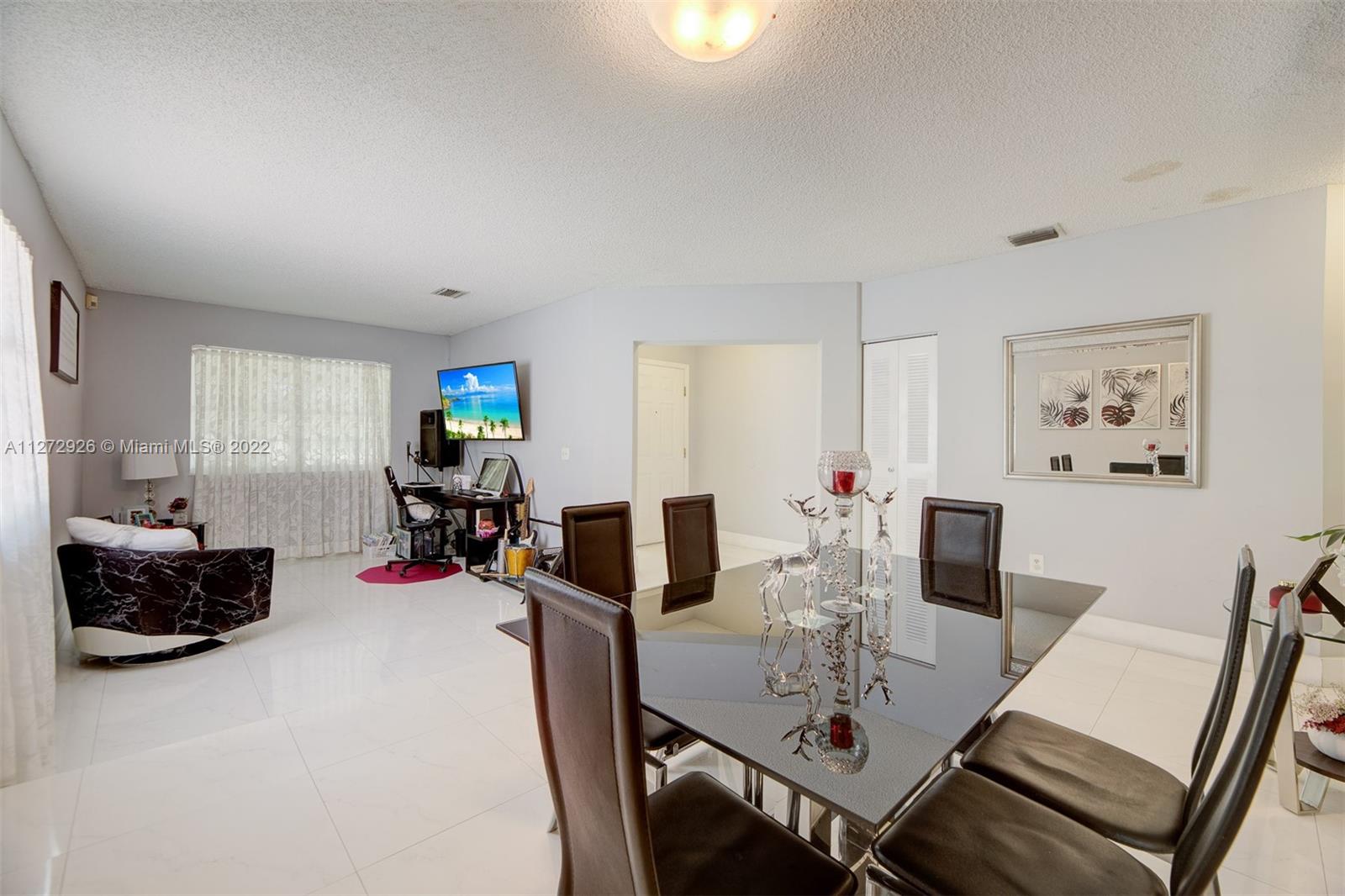 14480 Southwest 112th Street Miami, FL 33186 - Photo 3 of 37 a view of a dining room with furniture