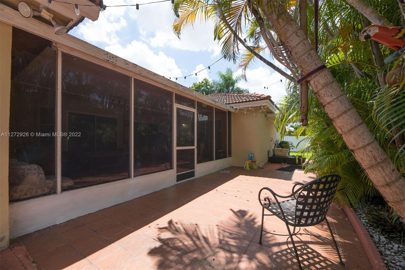 14480 Southwest 112th Street Miami, FL 33186 - Photo 31 of 37 a view of a house with backyard and sitting area