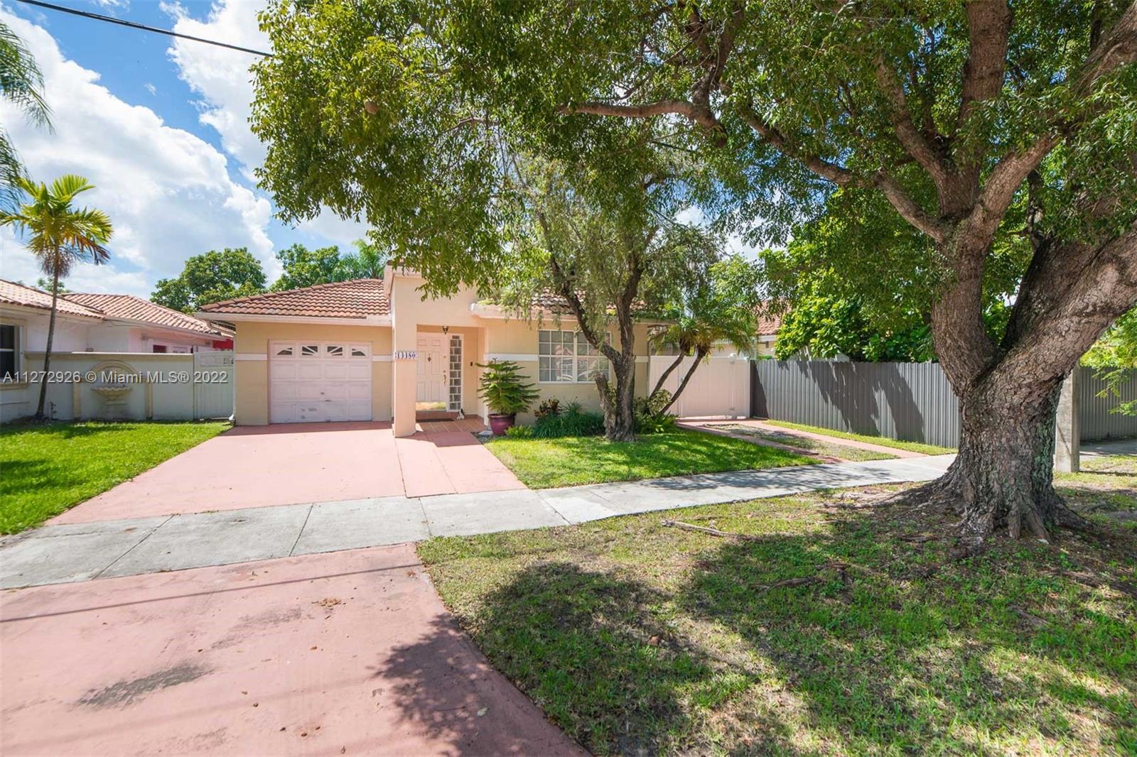 14480 Southwest 112th Street Miami, FL 33186 - Photo 33 of 37 a view of a yard with plants and a large tree