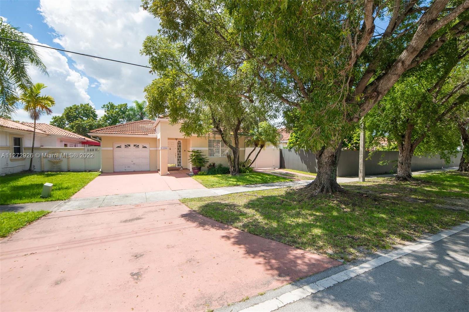 14480 Southwest 112th Street Miami, FL 33186 - Photo 34 of 37 a front view of a house with yard and green space