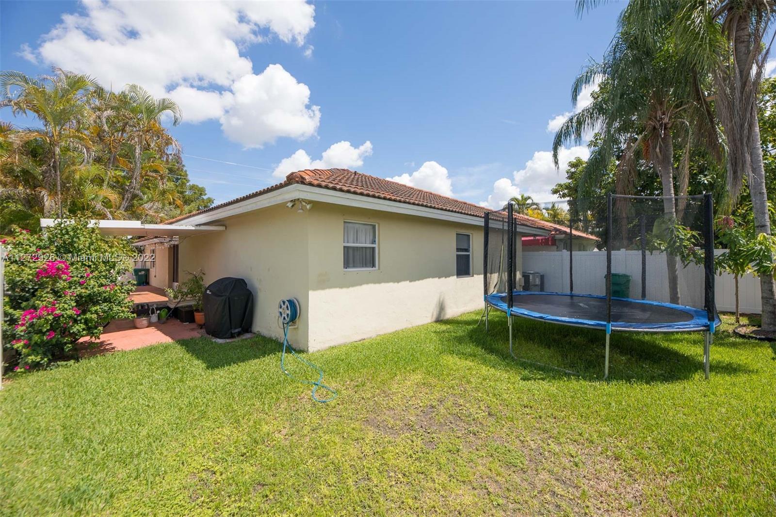 14480 Southwest 112th Street Miami, FL 33186 - Photo 36 of 37 a view of a house with a yard and sitting area