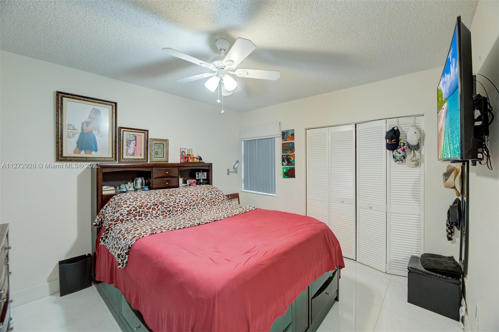 14480 Southwest 112th Street Miami, FL 33186 - Photo 8 of 37 a bedroom with a bed and a chandelier