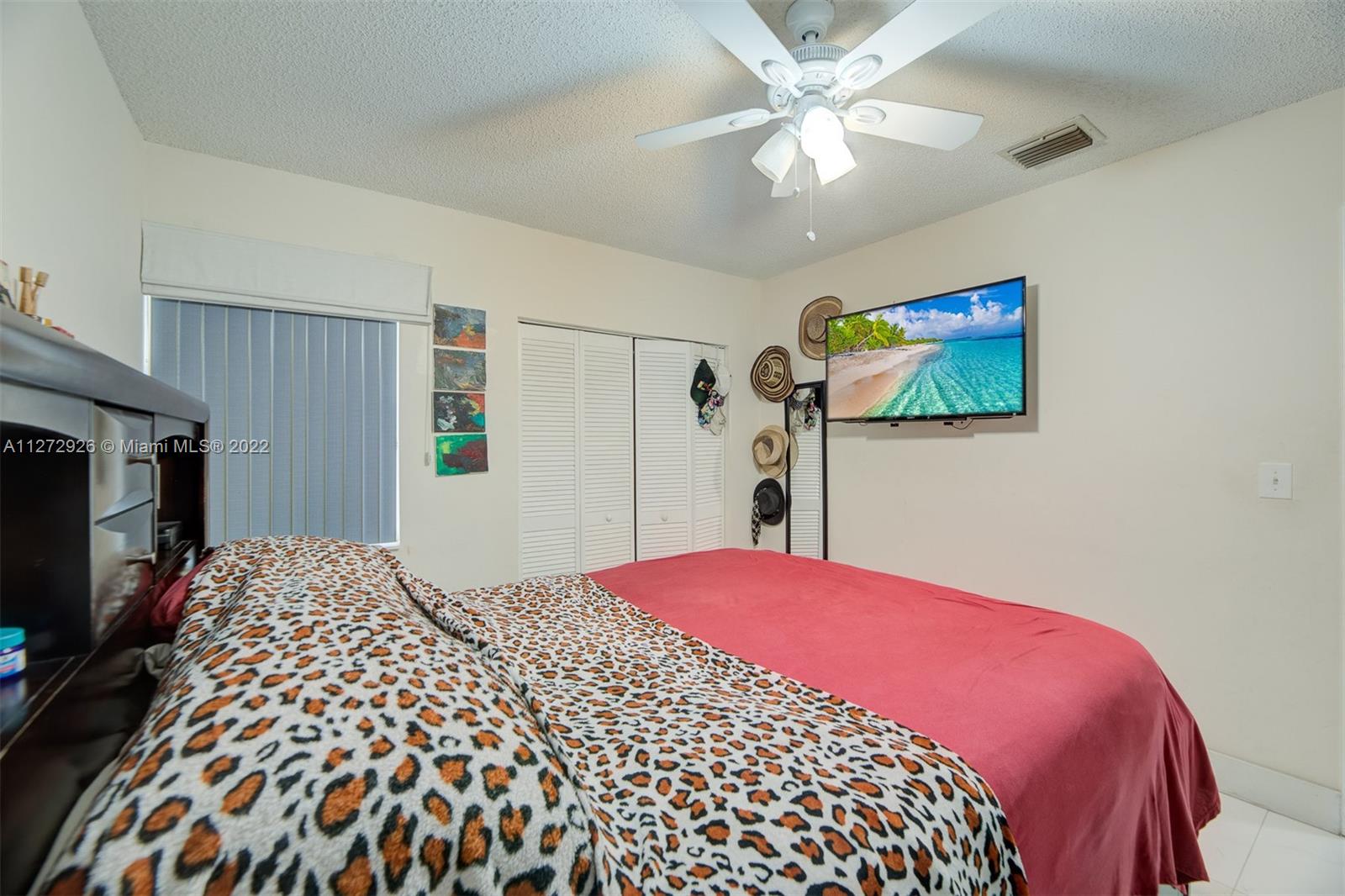 14480 Southwest 112th Street Miami, FL 33186 - Photo 9 of 37 a bedroom with a bed and a flat screen tv