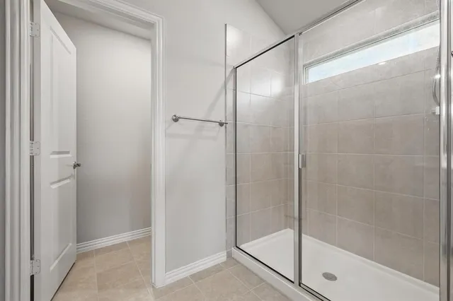 a bathroom with a glass shower door