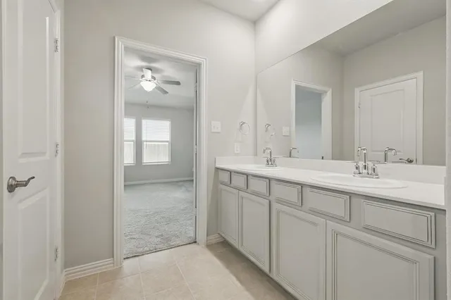 a bathroom with 2 sink and a mirror