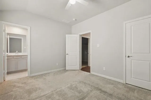 a view of an empty room with a kitchen