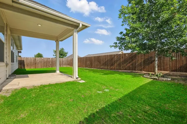 a view of yard with swimming pool and furniture