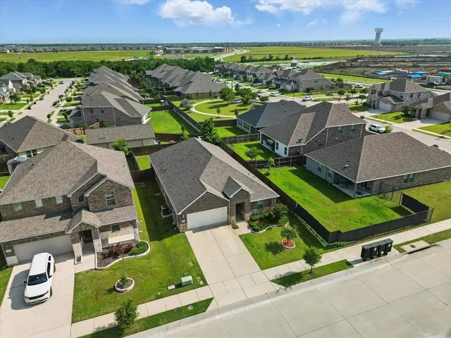 an aerial view of houses with yard