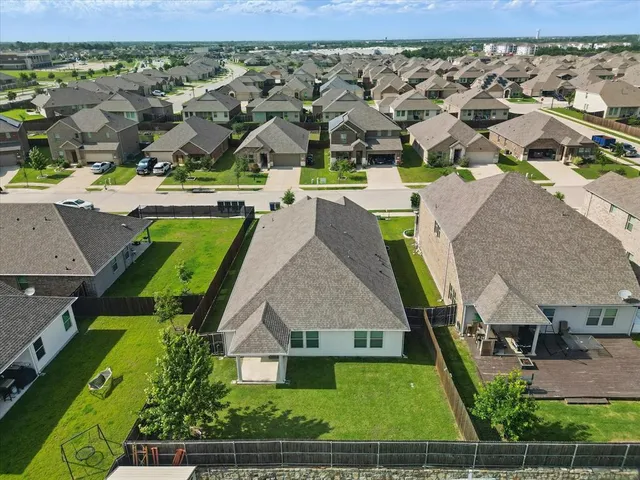 an aerial view of residential houses with outdoor space