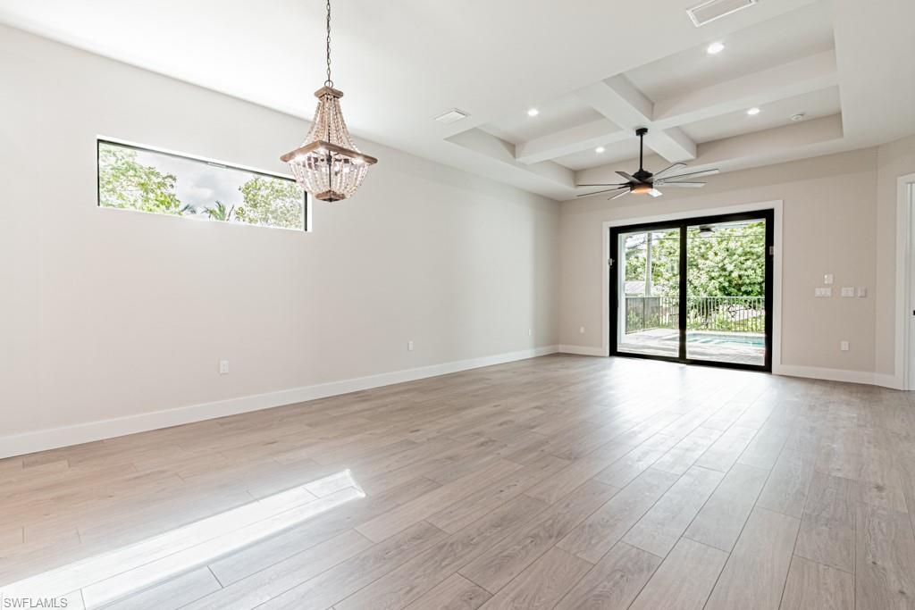3552 Hibiscus Avenue Naples, FL 34104 - Photo 16 of 34 an empty room with wooden floor windows and ceiling fan