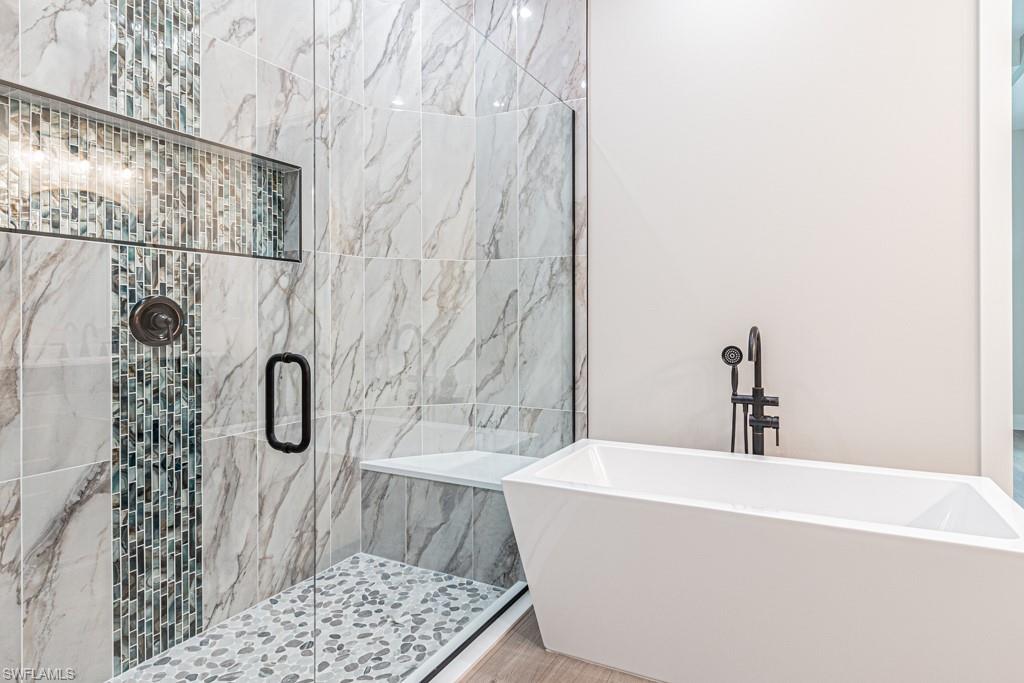 3552 Hibiscus Avenue Naples, FL 34104 - Photo 26 of 34 a bathroom with a bathtub and shower