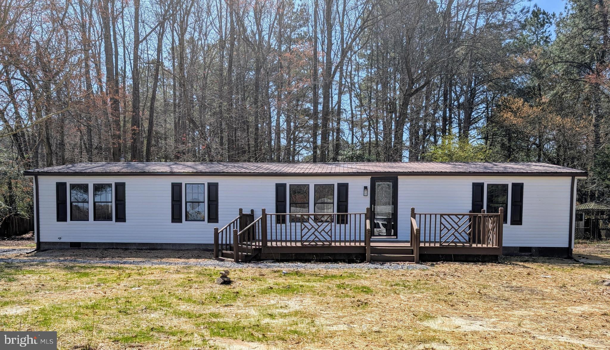 14018 Oak Branch Road Delmar, DE 19940 - Photo 1 of 20 a backyard of a house with yard table and chairs