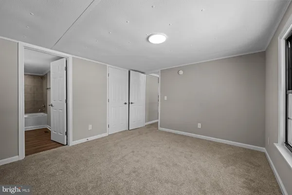 a view of an empty room and closet