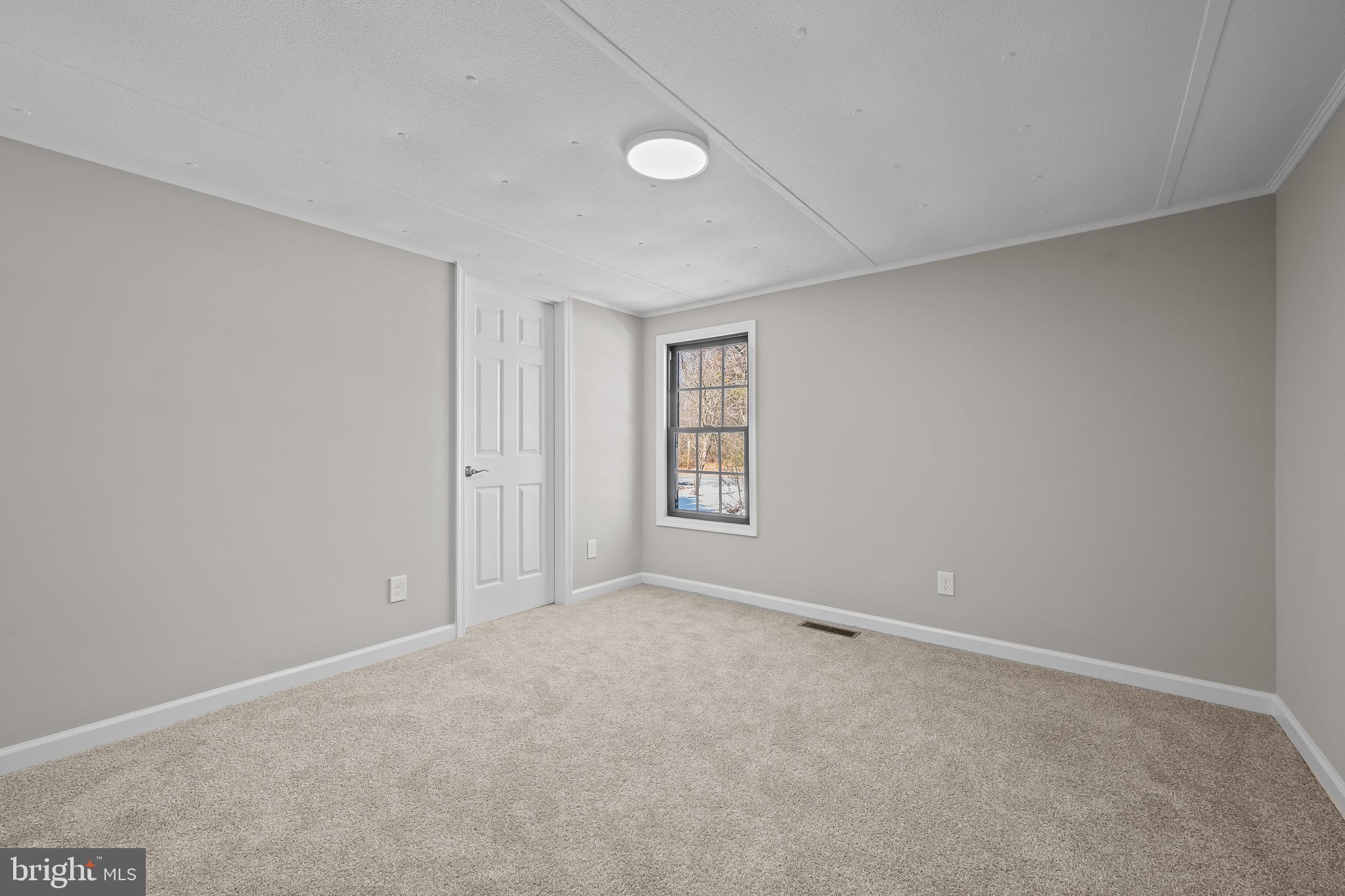 14018 Oak Branch Road Delmar, DE 19940 - Photo 14 of 20 a view of an empty room with a window