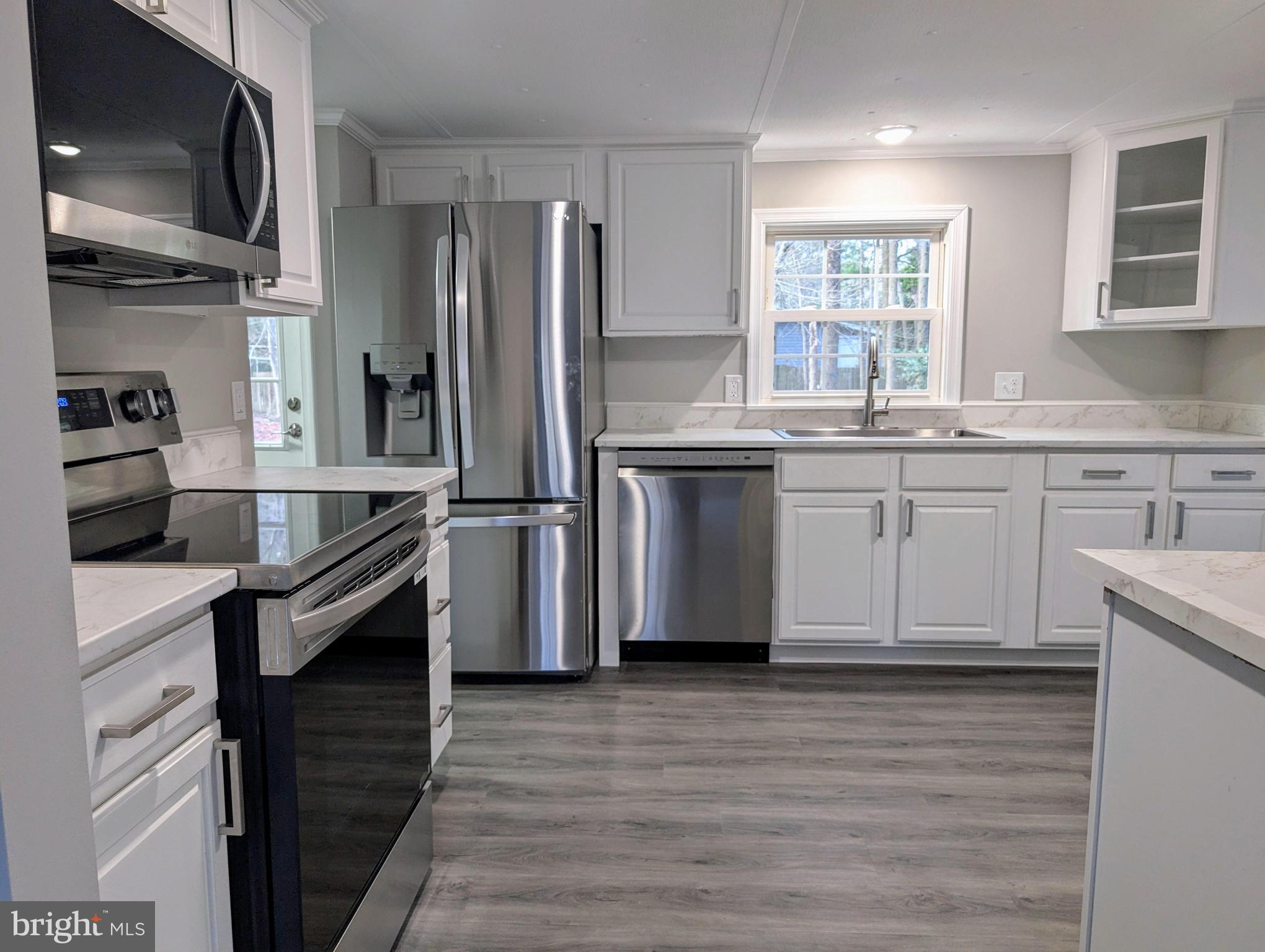 14018 Oak Branch Road Delmar, DE 19940 - Photo 2 of 20 a kitchen with granite countertop a sink stainless steel appliances and cabinets