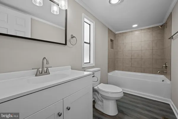 a bathroom with a sink a toilet and a bathtub