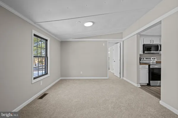 an empty room with windows and cabinet