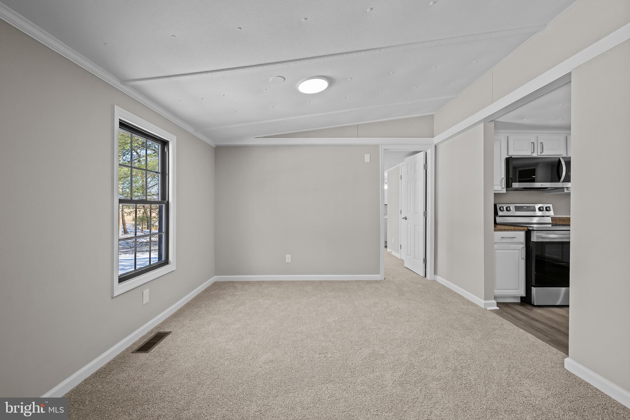 14018 Oak Branch Road Delmar, DE 19940 - Photo 9 of 20 an empty room with windows and cabinet