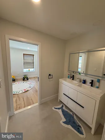a spacious bedroom with a bed and a flat screen tv