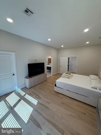 a spacious bedroom with a bed and a table