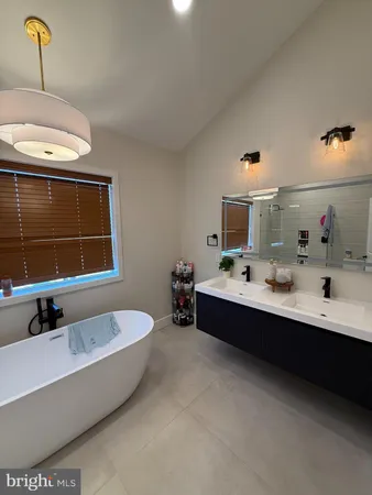 a bathroom with a toilet mirror vanity and toilet
